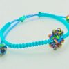 Pulsera ajustable tejida a mano con flor de cristales facetados