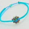 Pulsera ajustable tejida a mano con flor de cristales facetados