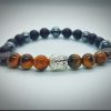 2026/01/1002582065.jpg Pulsera de Buda plateado con piedras naturales ónix, hematita y ojo de tigre